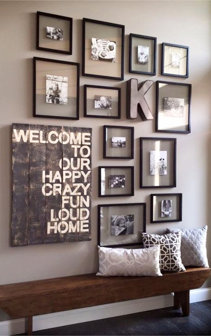 Using all the same frames on your gallery wall can give it a neat and organized look.  LOVE that rustic / pallet bench too!  Gallery wall ideas for your foyer