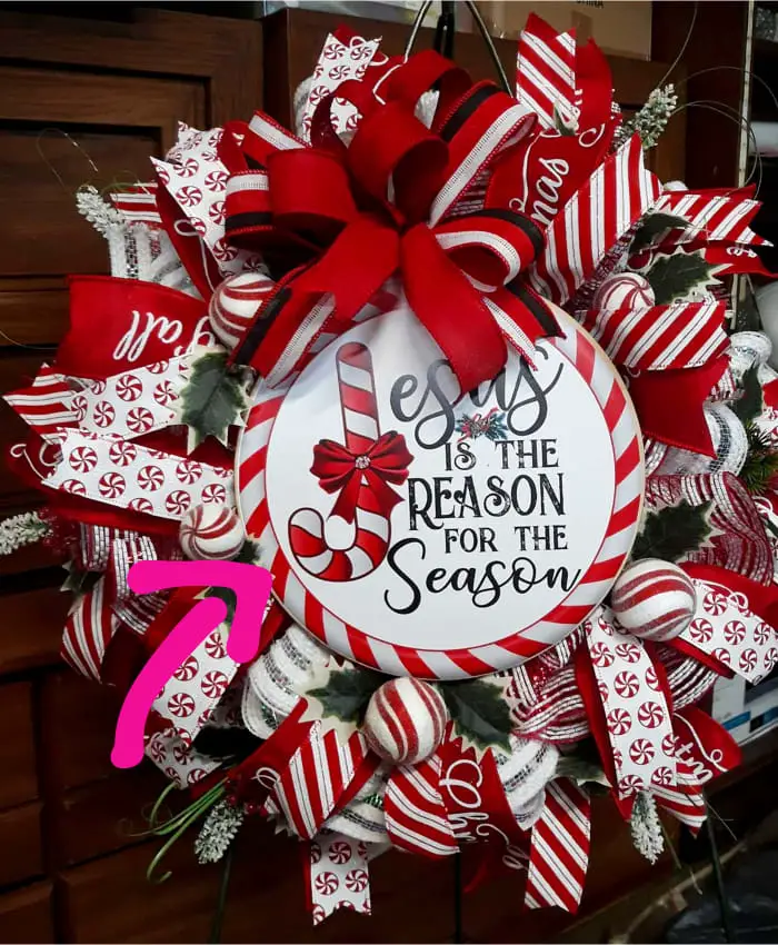 handmade christmas wreath ideas - bows, ribbons and jesus is the reason for the season religious saying in the center