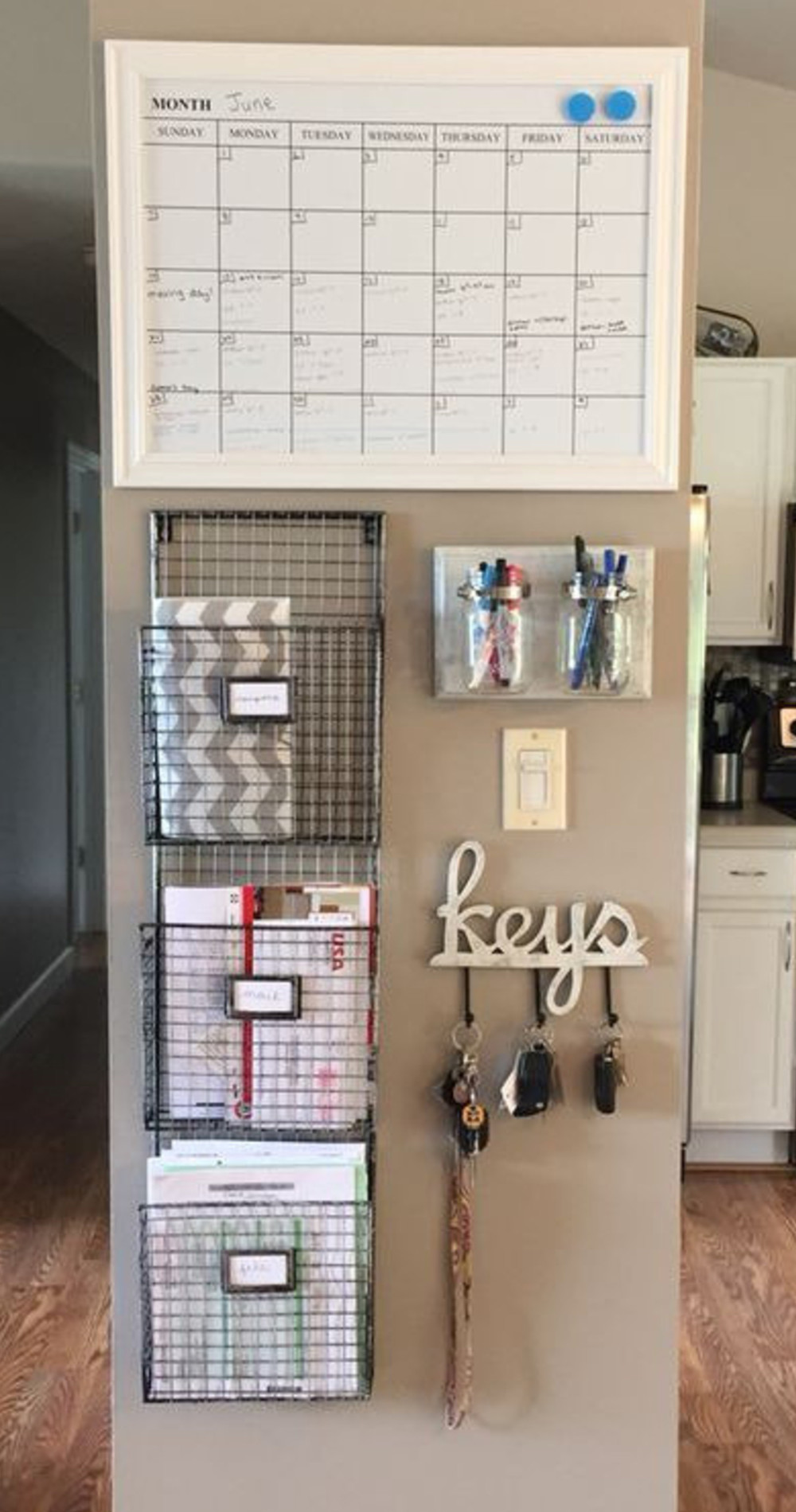 Neatly organized home command center organization wall in kitchen